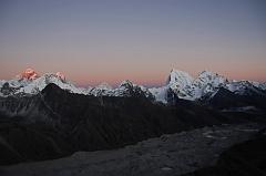 10 Gokyo Ri 08-1 Everest, Nuptse, Lhotse, Makalu, Cholatse, Tawache From Gokyo Ri Sunset Ends The last rays of the sun highlight Mount Everest and Lhotse, while a warm glow surrounds Nuptse, Makalu, Cholatse, and Taweche. The Nguzumpa Glacier is in shadow below.
